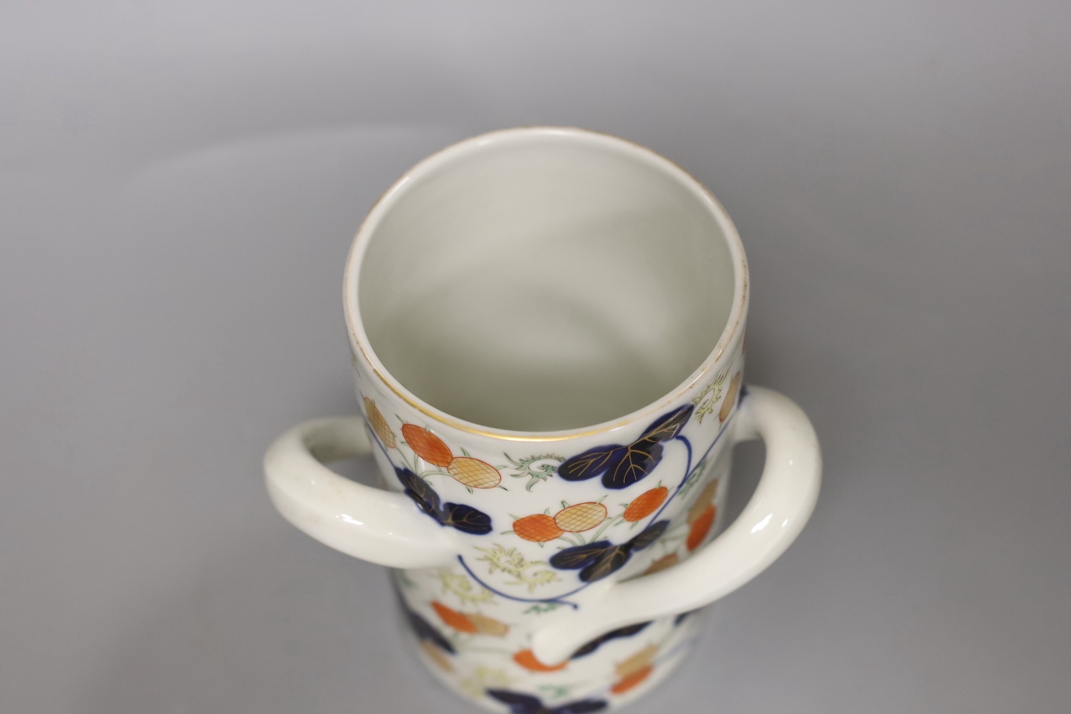 A Chinese Canton decorated famille rose teapot and a Japanese Fukugawa three handled vase (2), tallest 15cm